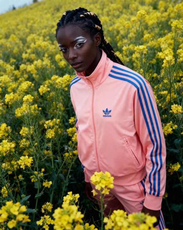 a woman standing in a field of yellow flowers