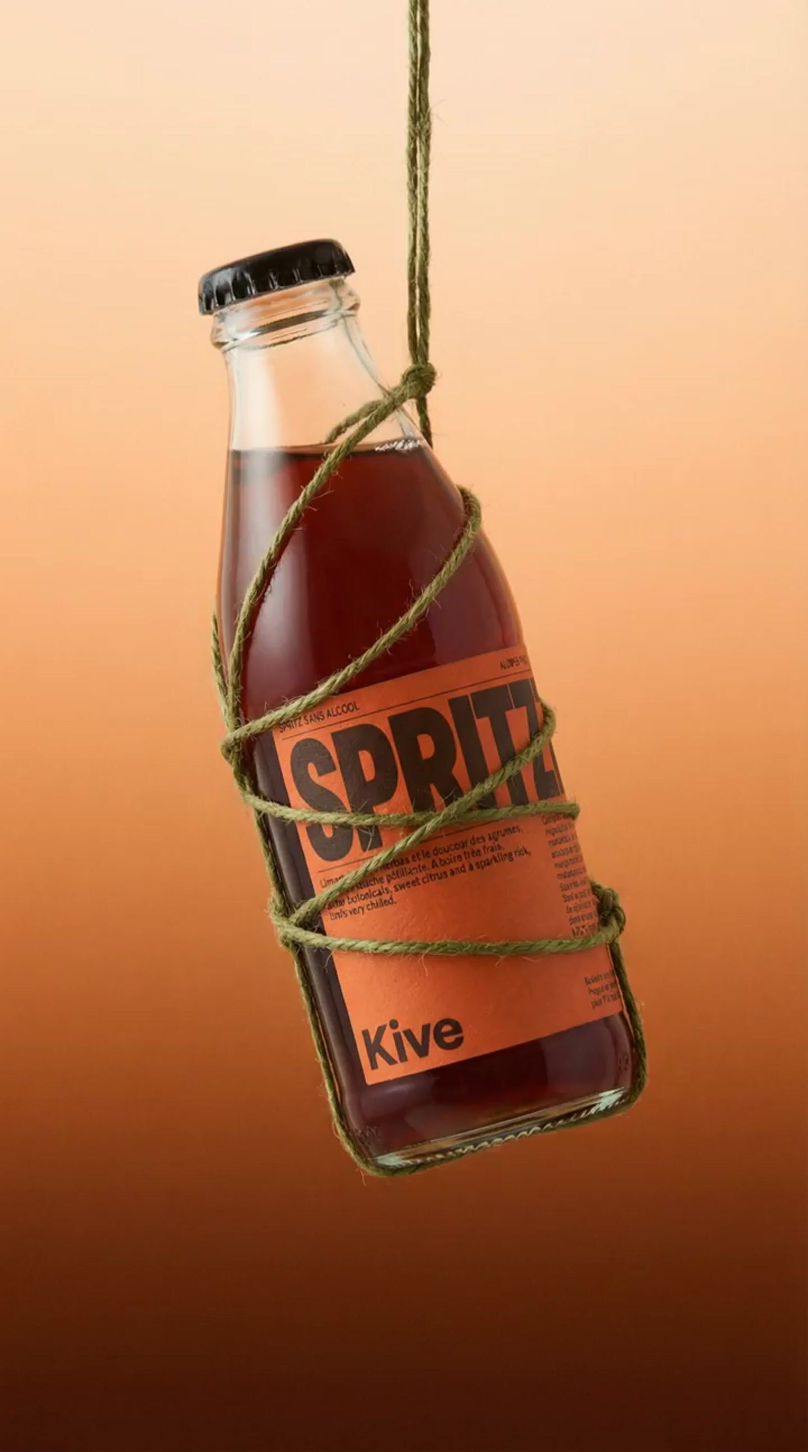 a bottle of soda hanging from a string