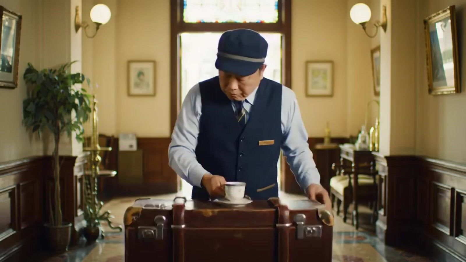 a man standing in a room with a suit case