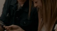 two girls looking at a cell phone together