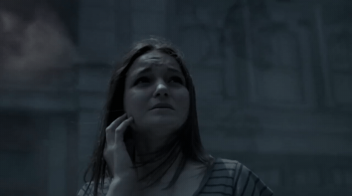 a woman talking on a cell phone in a dark room