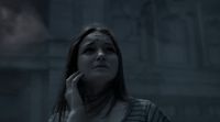 a woman talking on a cell phone in a dark room
