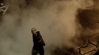 a man standing in the middle of a cloud of smoke