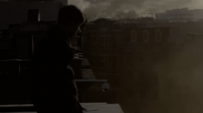 a person standing on a roof with smoke coming out of the sky