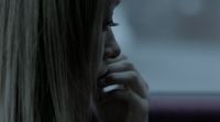 a blonde woman talking on a cell phone