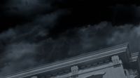 a black and white photo of a building with clouds in the background