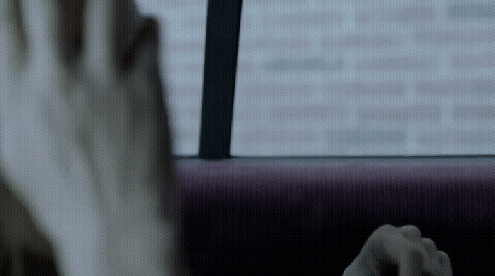 a woman sitting on a bus looking out the window