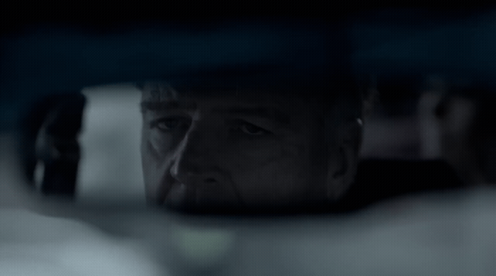 a man looking out the window of a car