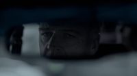 a man looking out the window of a car