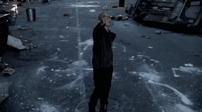 a man standing in a parking lot talking on a cell phone