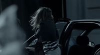 a woman getting out of a car at night