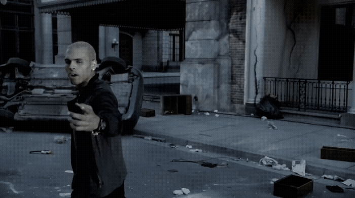 a man standing on a city street holding a cell phone