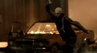 a man in a black jacket jumping in the air