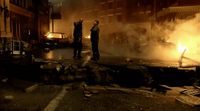 a group of people standing on a street next to a fire