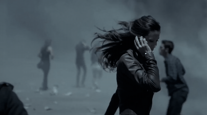 a woman talking on a cell phone in a foggy area