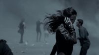 a woman talking on a cell phone in a foggy area