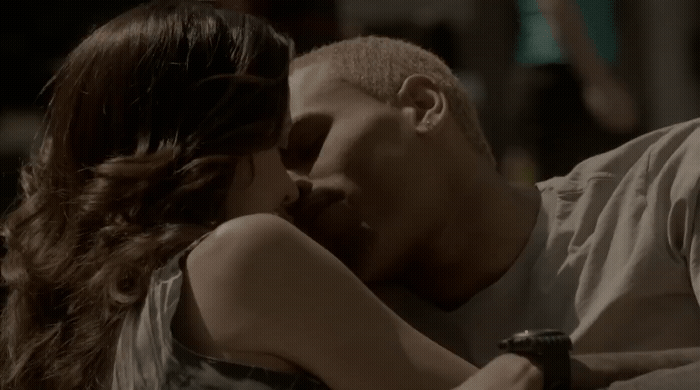 a man kissing a woman on the cheek