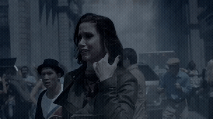a woman talking on a cell phone in front of a crowd of people