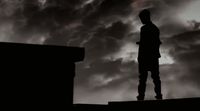 a man standing on top of a roof under a cloudy sky