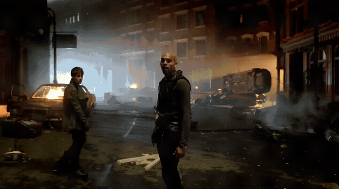 a couple of men standing next to each other on a street