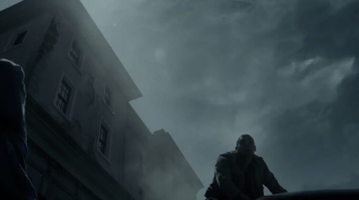 a man standing in front of a tall building