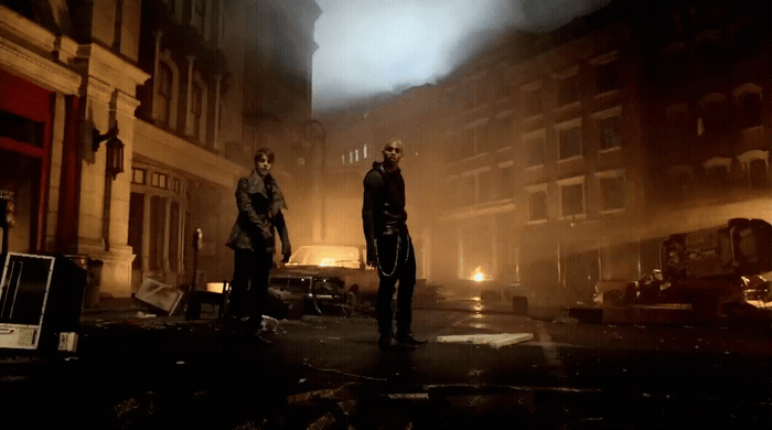 a couple of men standing next to each other on a street