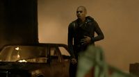 a man standing next to a car in a room