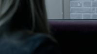 a woman sitting on a bus looking out the window