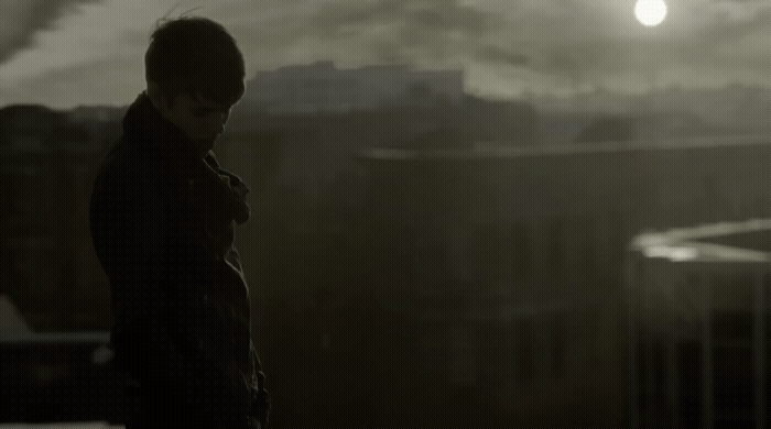 a man standing in front of a city skyline