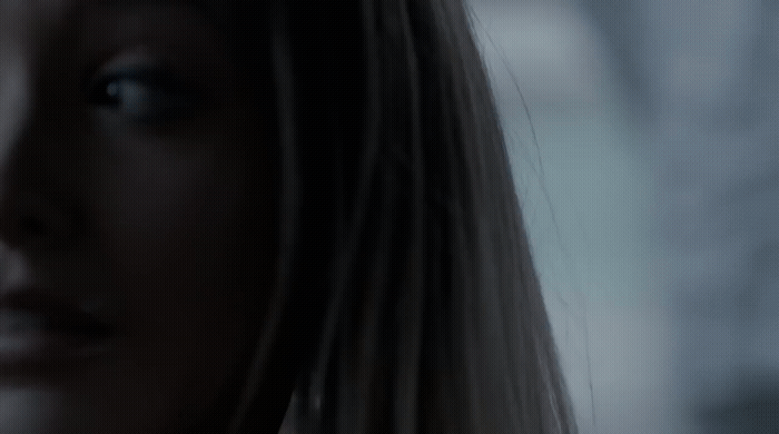 a close up of a woman's face with a blurry background