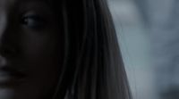 a close up of a woman's face with a blurry background