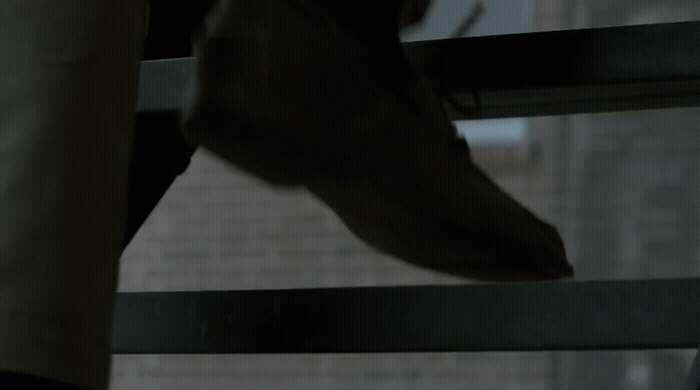 a close up of a person's foot on a railing
