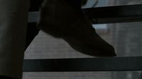 a close up of a person's foot on a railing