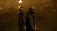 a couple of people that are standing in the dark