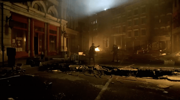a dark city street at night with a fire hydrant