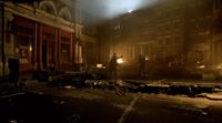 a dark city street at night with a fire hydrant