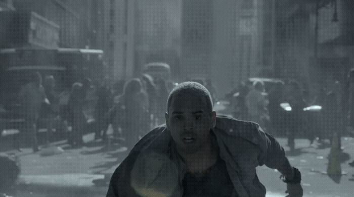 a man running through a city street in the rain