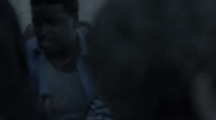 a blurry photo of a man in a white shirt