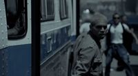 a man walking next to a bus on a street