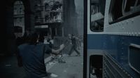 a man walking down a street next to a bus
