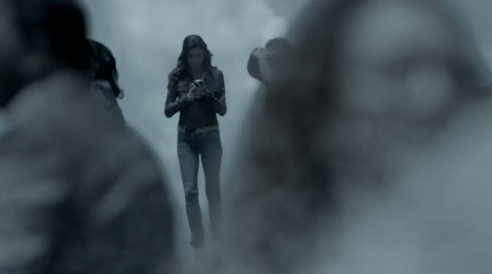 a woman standing in front of a group of people
