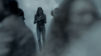 a woman standing in front of a group of people