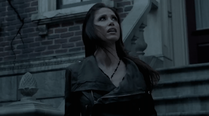 a woman standing in front of a building