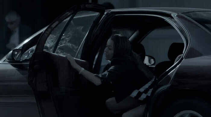 a woman sitting in the driver's seat of a car