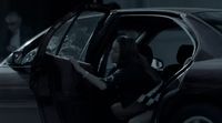 a woman sitting in the driver's seat of a car