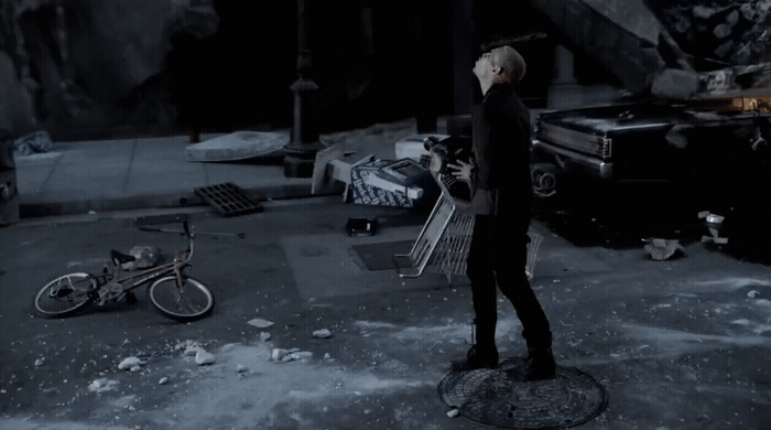 a man standing next to a bike in a dark room