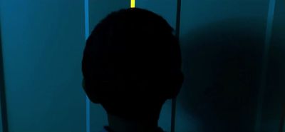 a silhouette of a person in a dark room