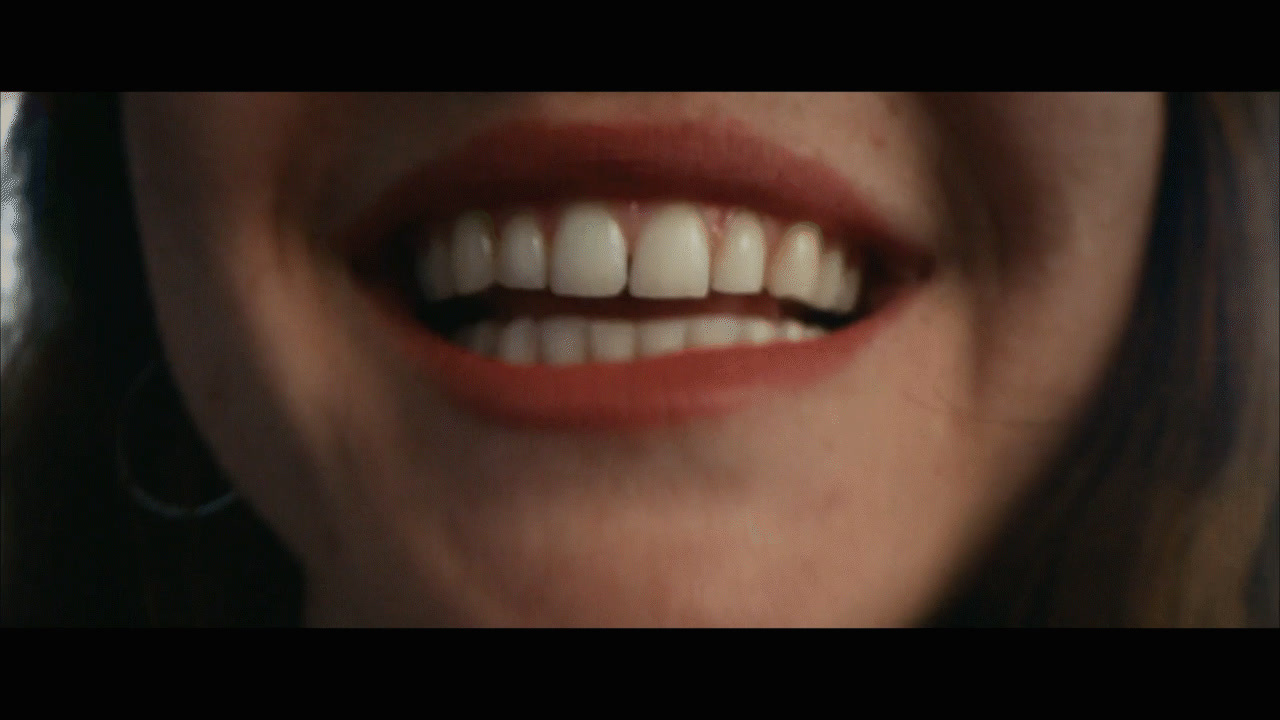 a close up of a woman's mouth with white teeth