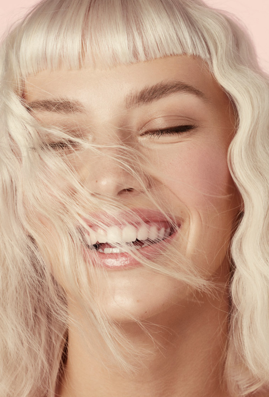 a woman with blonde hair and a smile on her face