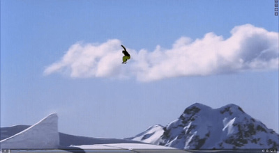 a bird flying in the sky over a mountain range